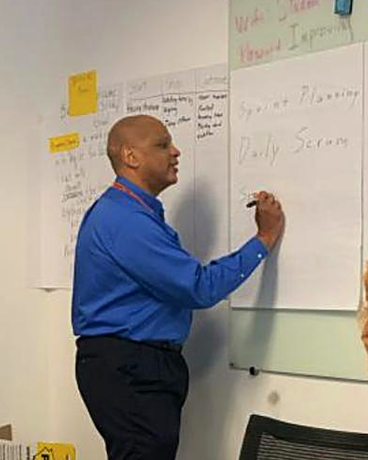 Fred Williams facilitating a sprint planning session at a whiteboard